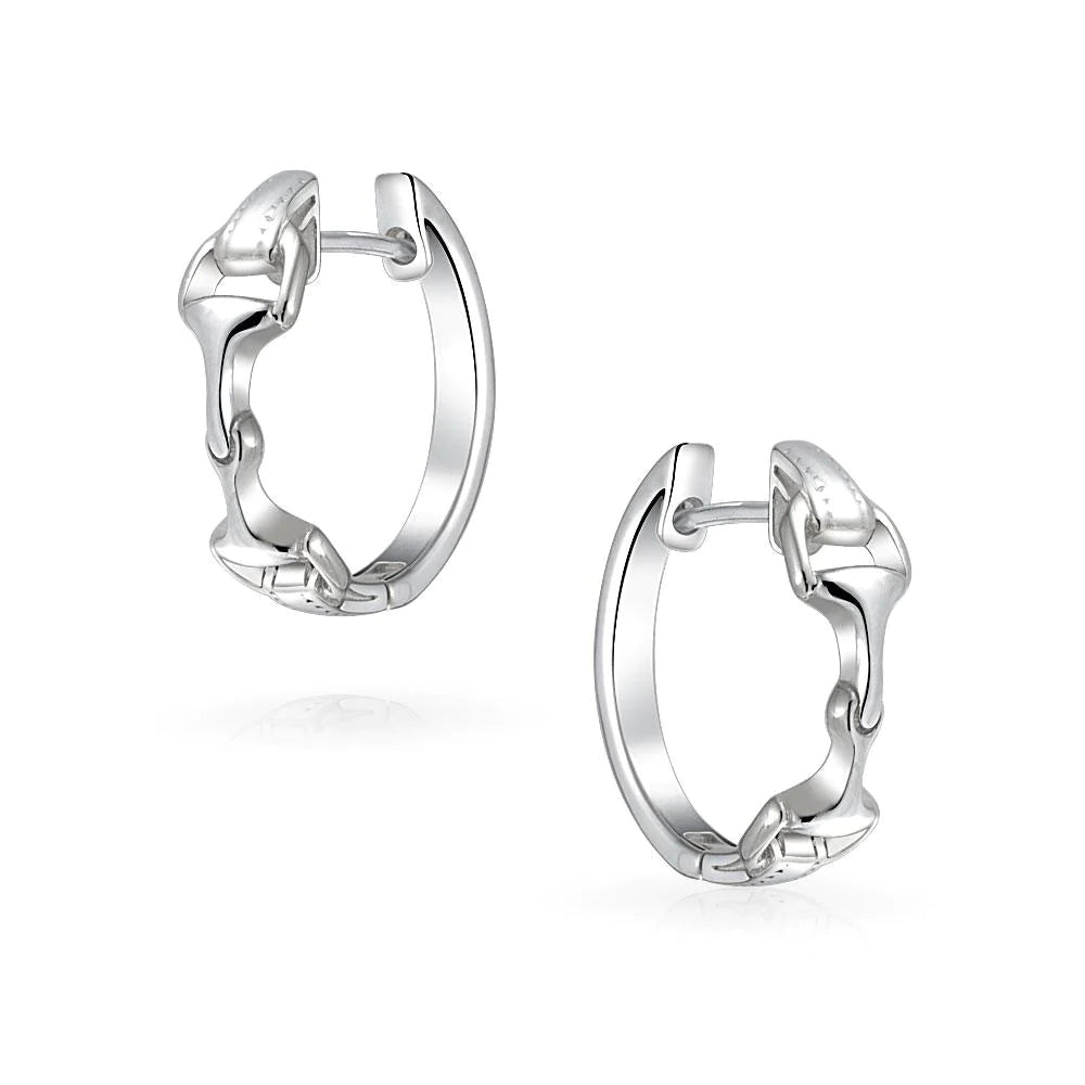 Sterling silver snaffle huggie earrings.